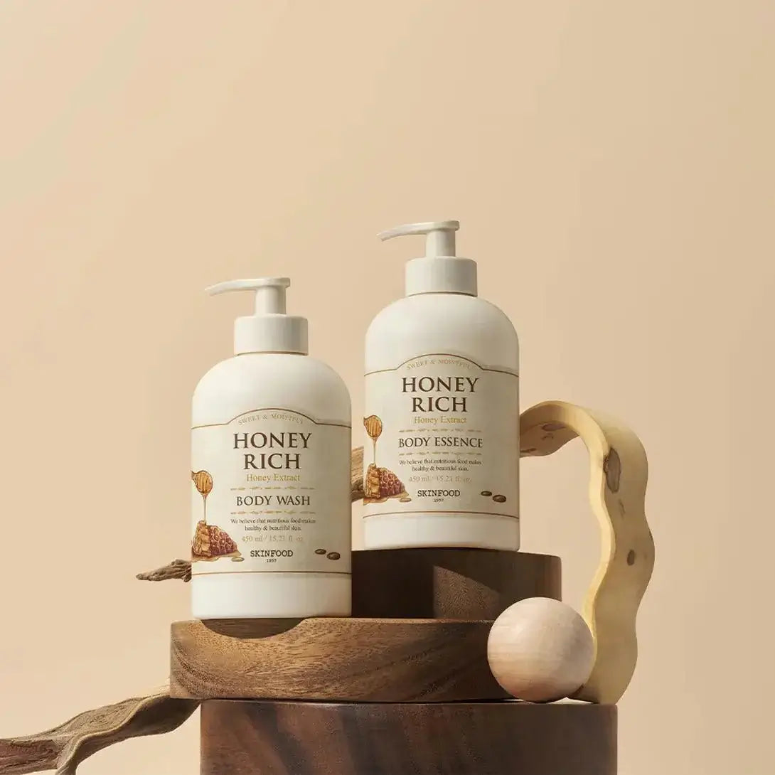 SKINFOOD Honey Rich Body Wash 450ml and Body Essence on a wooden display for skin nourishment.
