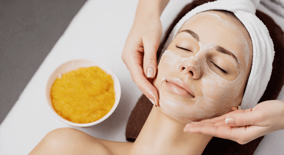 Woman receiving exfoliating facial treatment with scrub in bowl, demonstrating exfoliation skin care guide.