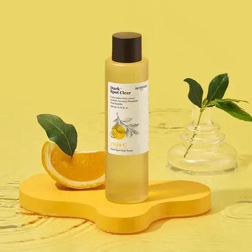 Facial toner on a yellow background showcasing the importance of facial toner for clear skin.