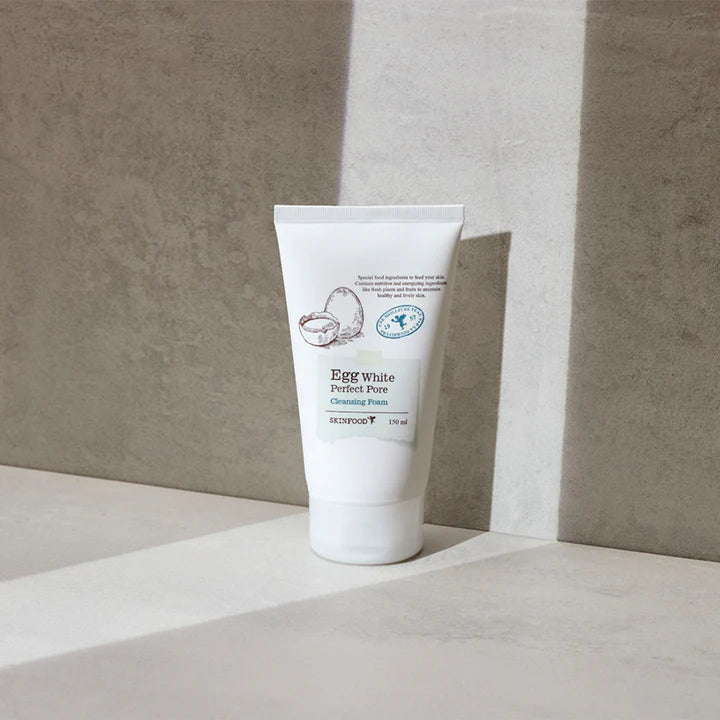 SKINFOOD Egg White Perfect Pore Cleansing Foam in a tube on a light surface