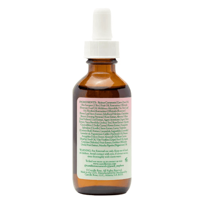 Camille Rose Rosemary Oil Strengthening Hair Drops ingredient list on amber bottle with dropper top