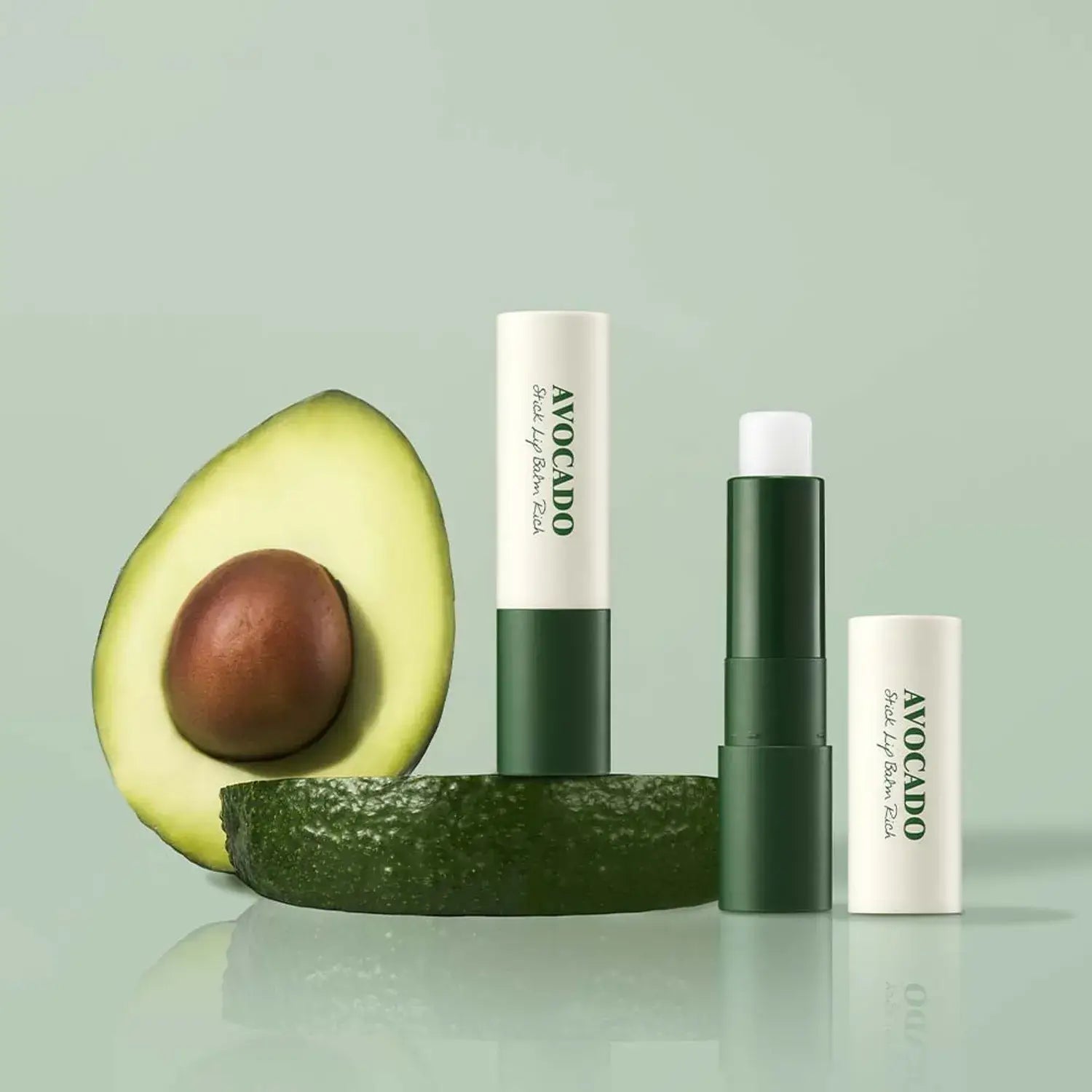 SKINFOOD avocado stick lip balm and fresh avocado slice showcasing nourishing ingredients for healthy lips.